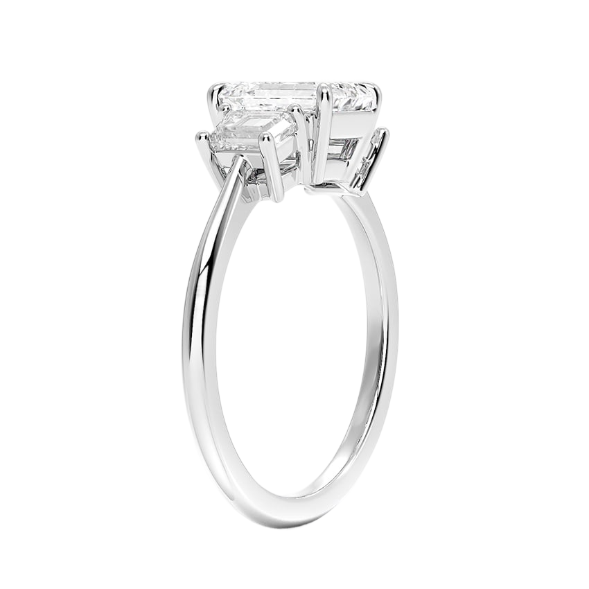 A silver engagement ring with a large, clear gemstone set in the center.