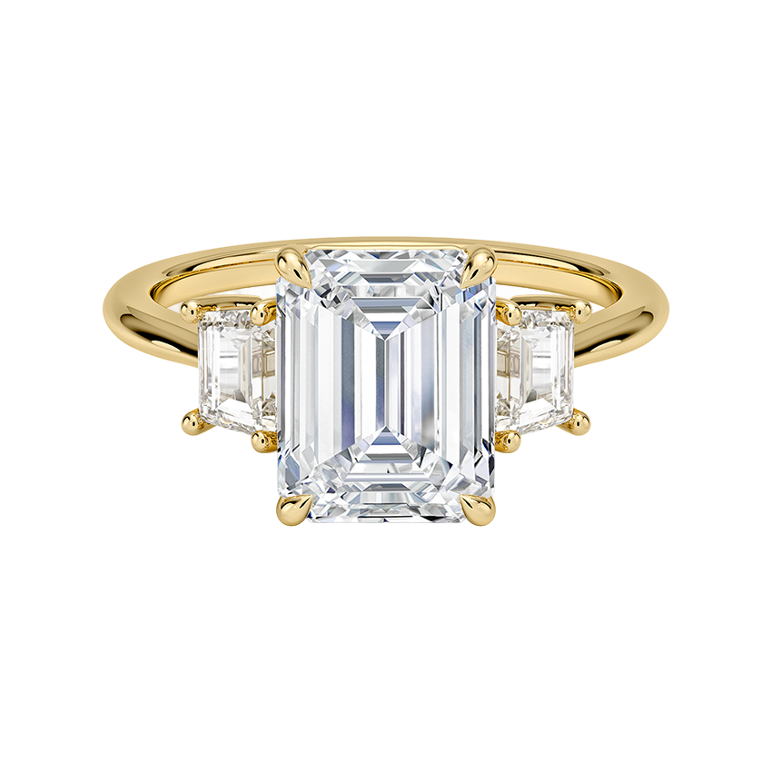 A gold ring with a large, clear gemstone in the center, surrounded by smaller gemstones.