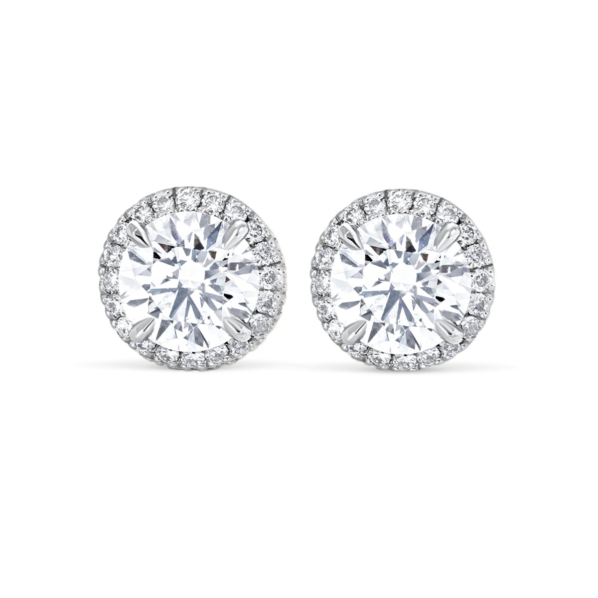 A pair of elegant earrings with large, clear diamonds set in a halo around the center.