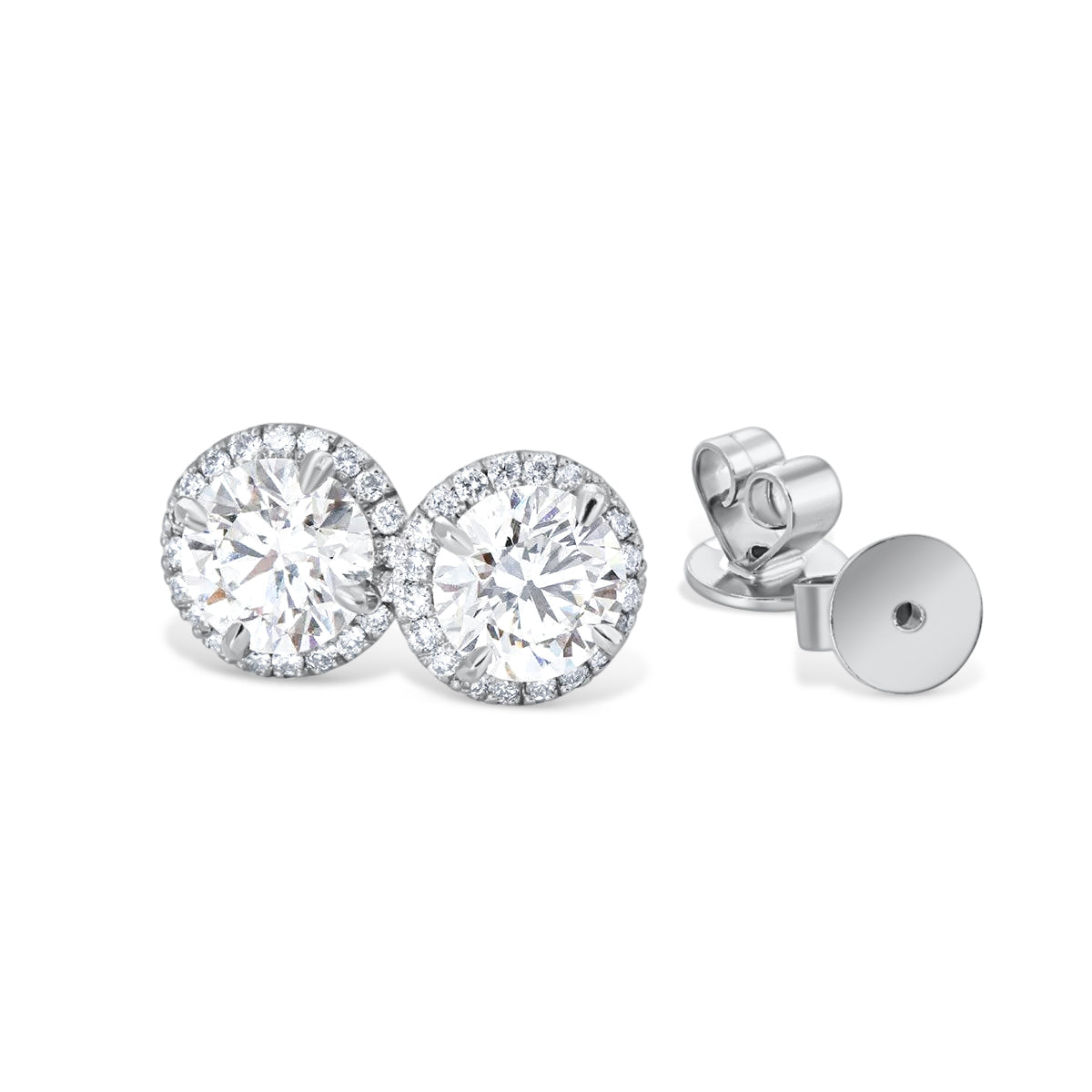 A pair of elegant diamond earrings with a halo of smaller diamonds around the center of each large diamond.